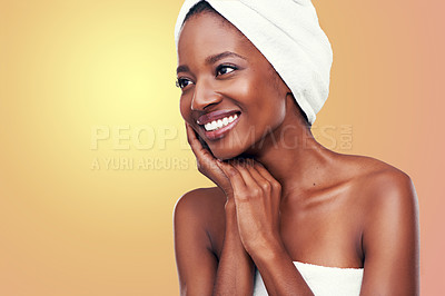 Buy stock photo Hair towel, smile and happy black woman in studio for skincare, wellness or body care on orange background. Beauty, cleaning or hands on face of African female model with cosmetic, shine or soft skin