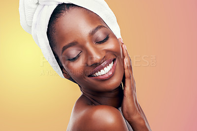 Buy stock photo Beauty, hair towel or happy black woman in studio for skincare, wellness and makeup on orange background. Dermatology, cleaning or hands on face of African female model with cosmetic, shine or glow