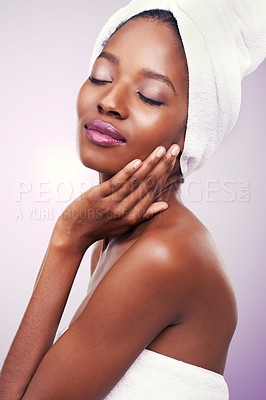 Buy stock photo Beauty, black woman or hair towel in studio with skincare, wellness or body care on purple background. Makeup, cleaning or hands on face of African female model with cosmetic, shine or glow results
