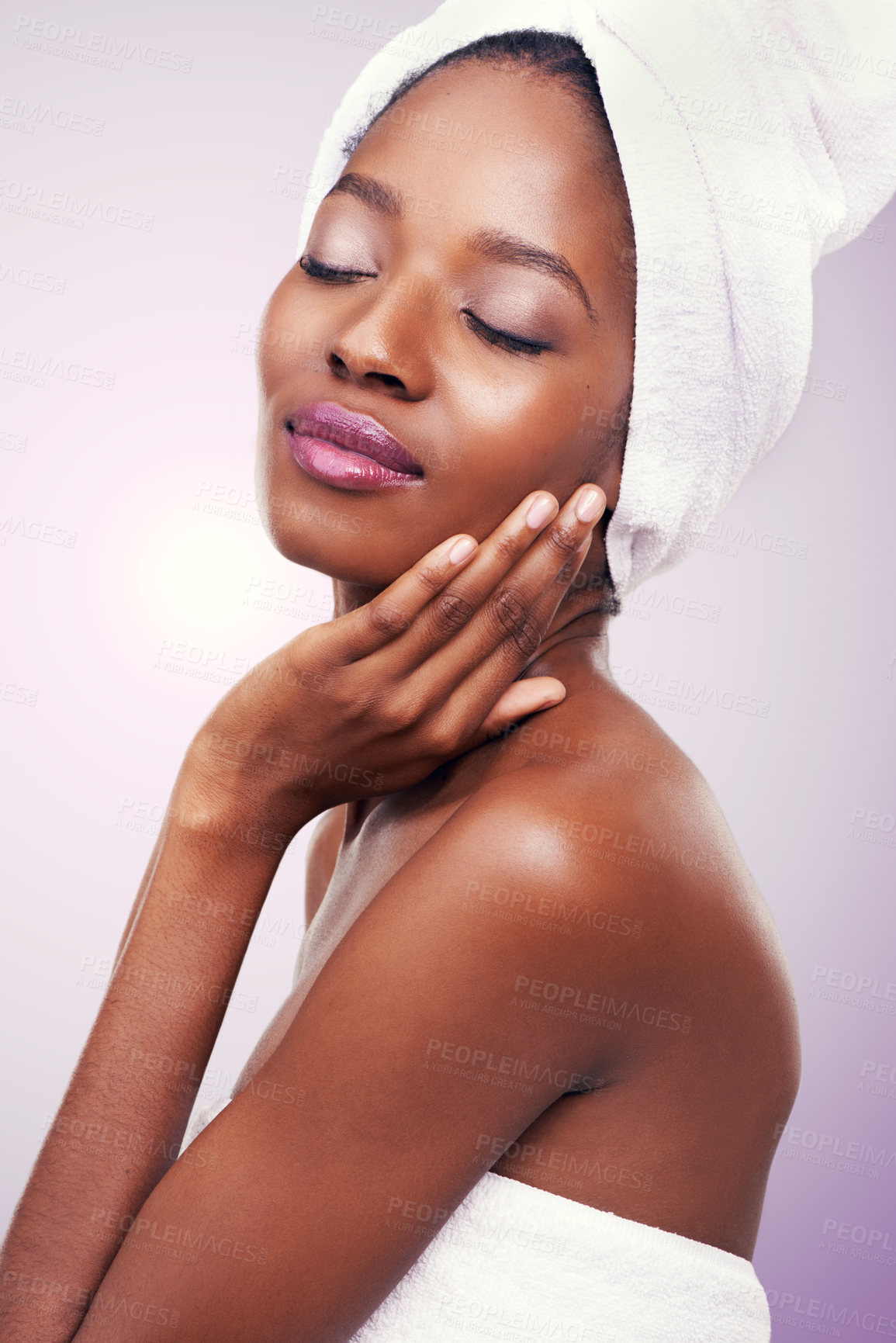 Buy stock photo Beauty, black woman or hair towel in studio with skincare, wellness or body care on purple background. Makeup, cleaning or hands on face of African female model with cosmetic, shine or glow results