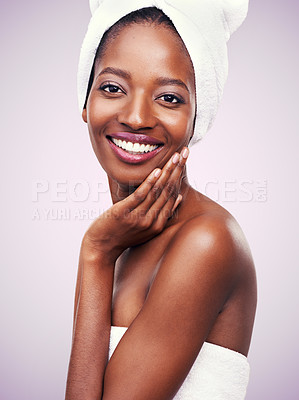 Buy stock photo Woman, portrait and towel for beauty in studio with skincare, dermatology and self care on a pink background. Face of a young model or African person with smile for hygiene, cosmetics or cosmetology