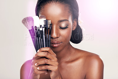 Buy stock photo Beauty, makeup tools and black woman with brushes on face in studio with cosmetic application glow. Skincare, brush and cosmetics, facial skin care model with luxury contour tool on white background.