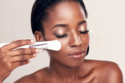 Buy stock photo Beauty, makeup and glow, black woman with brush on face in studio with cosmetic application tool. Skincare, healthy blush and cosmetics, facial skin care model with luxury contour on white background