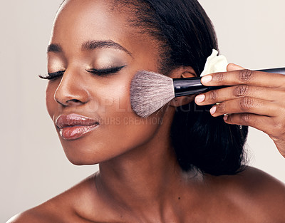 Buy stock photo Beauty, makeup and black woman with brush on face in studio and cosmetic application tool. Skincare, blush and cosmetics, facial skin care model with happiness and luxury shine on white background.