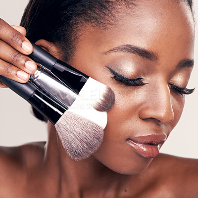 Buy stock photo Beauty, makeup and brushes on face, black woman with cosmetic tools in studio with application tool. Skincare, blush and cosmetics, closeup of facial care model with luxury powder on white background