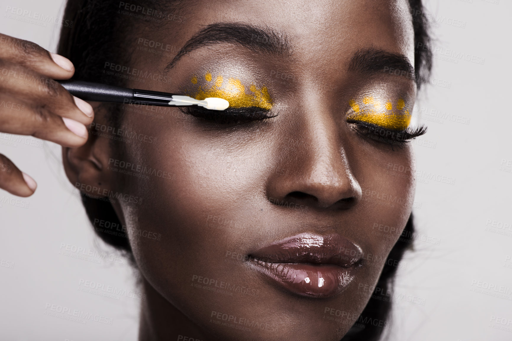 Buy stock photo Studio shot of a beautiful young woman applying eye makeup