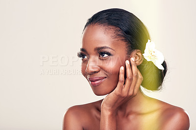 Buy stock photo Woman, face and flower for beauty in studio with organic cosmetics, natural glow and self care or happy. Model, african person or smile for cosmetology, facial treatment or mockup on white background