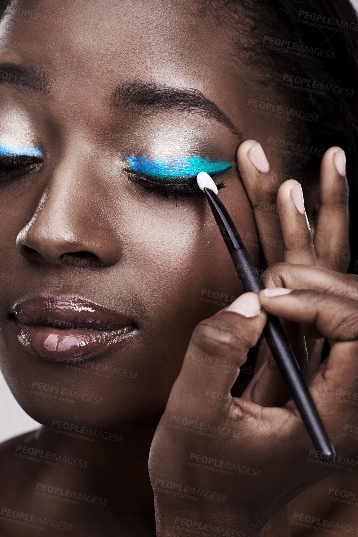 Buy stock photo Brush, makeup and face of black woman with cosmetics for wellness, beauty and model. Cosmetology, skincare and person with tools for makeover application, blue eyeshadow and products in studio