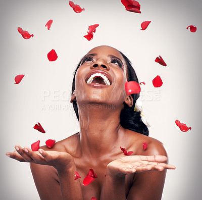 Buy stock photo Flower, throw and black woman in studio for makeup, beauty or wellness on grey background. Floral confetti, smile and African model with soft cosmetics, shine or organic, fun and transformation