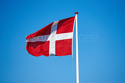 Buy stock photo Flag, blue sky and denmark with red and white cross for symbol of scandinavian country or danish state. Wind, pole and colorful representation of Dannebrog, history or nation in Copenhagen or Europe