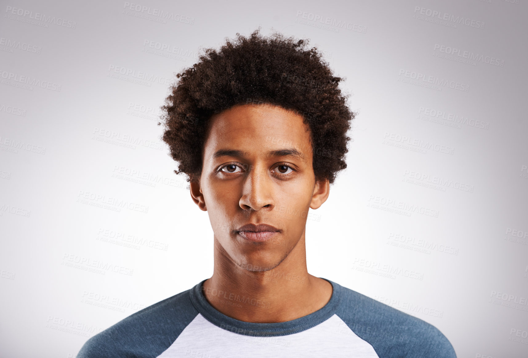 Buy stock photo Studio shot of a young man posing against a gray background