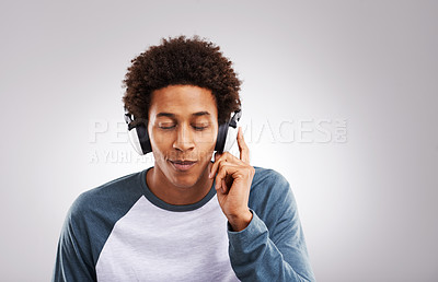 Buy stock photo Black man, headphones and smile for music listening, online radio or relax against a studio background. Male person, rap or hip hop audio track playing on wireless media headsets for playlist