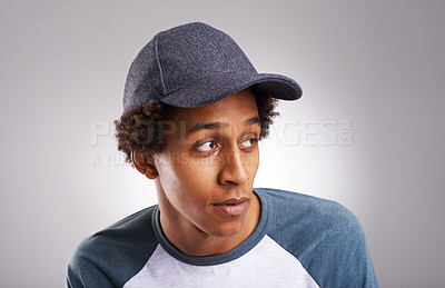 Buy stock photo Cool guy, fashion and cap in studio for trendy style or funky and creative aesthetic. African man, generation z or male fashionista with confident attitude in designer apparel wear on grey background