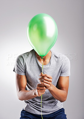 Buy stock photo Man, studio and balloon for fun on background, celebration or surprise or retail promotion with decoration item. Male person, playful and sale on isolated on white backdrop with mockup space