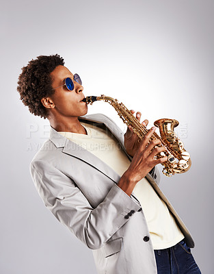 Buy stock photo Saxophone, man and performance with jazz artist, creative and music on a grey studio background. African person, musician and model with instrument and classic genre with hobby, melody and expression