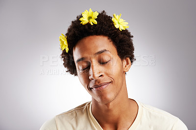 Buy stock photo Eyes closed, natural and black man with hair or flowers, plant and petal decoration or happy isolated on white background. Male person, gen z guy or student with comic hairstyle on studio backdrop