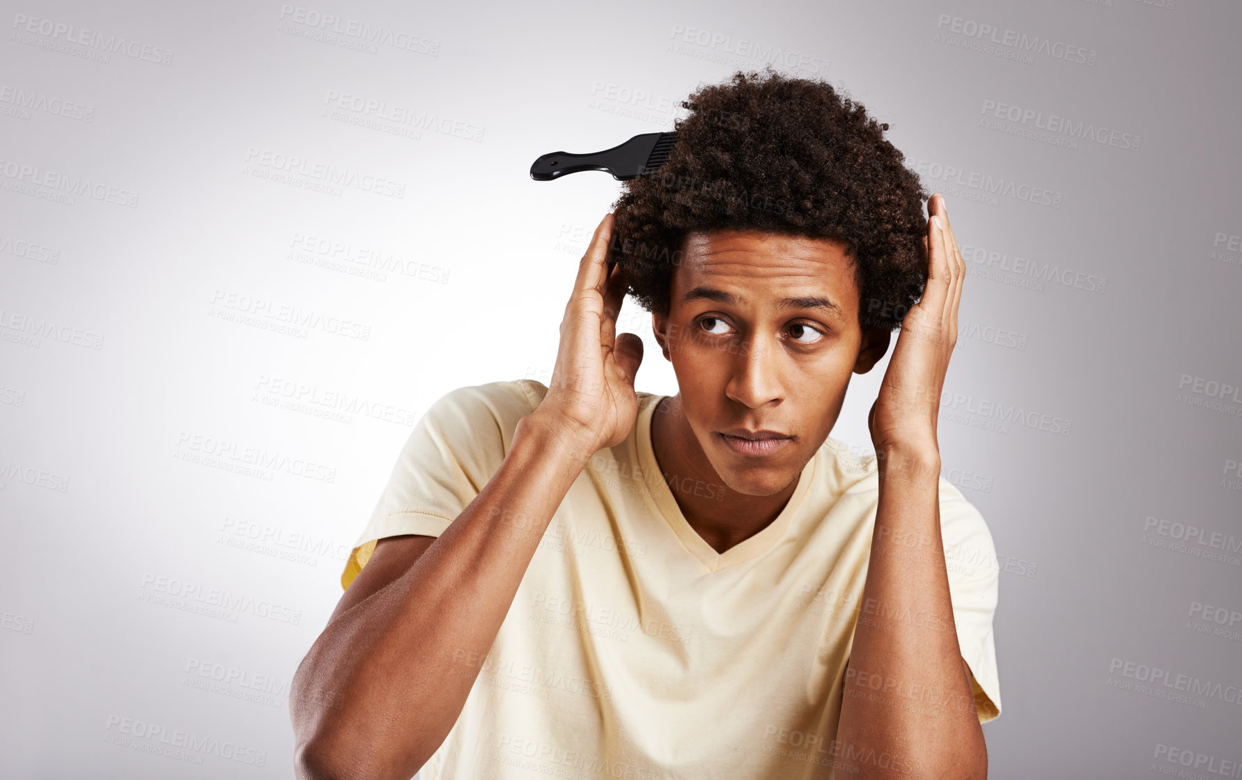 Buy stock photo Comb, afro and black man with hair or haircare, combing and styling by mockup space isolated on gray background. Male person, gen z guy and student with natural hairstyle on studio backdrop