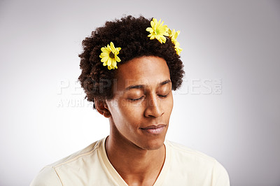 Buy stock photo Eyes closed, black man and natural hair or sunflowers, plant and petal decoration or relax isolated on white background. Male person, gen z guy or student with comic hairstyle on studio backdrop