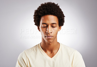 Buy stock photo Studio shot of a young man posing against a gray background