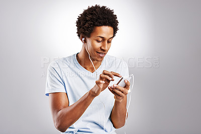 Buy stock photo Black man, listening to music and smartphone with audio, radio and live streaming on a white studio background. African person, guy and model with cellphone and mobile user with digital app and sound