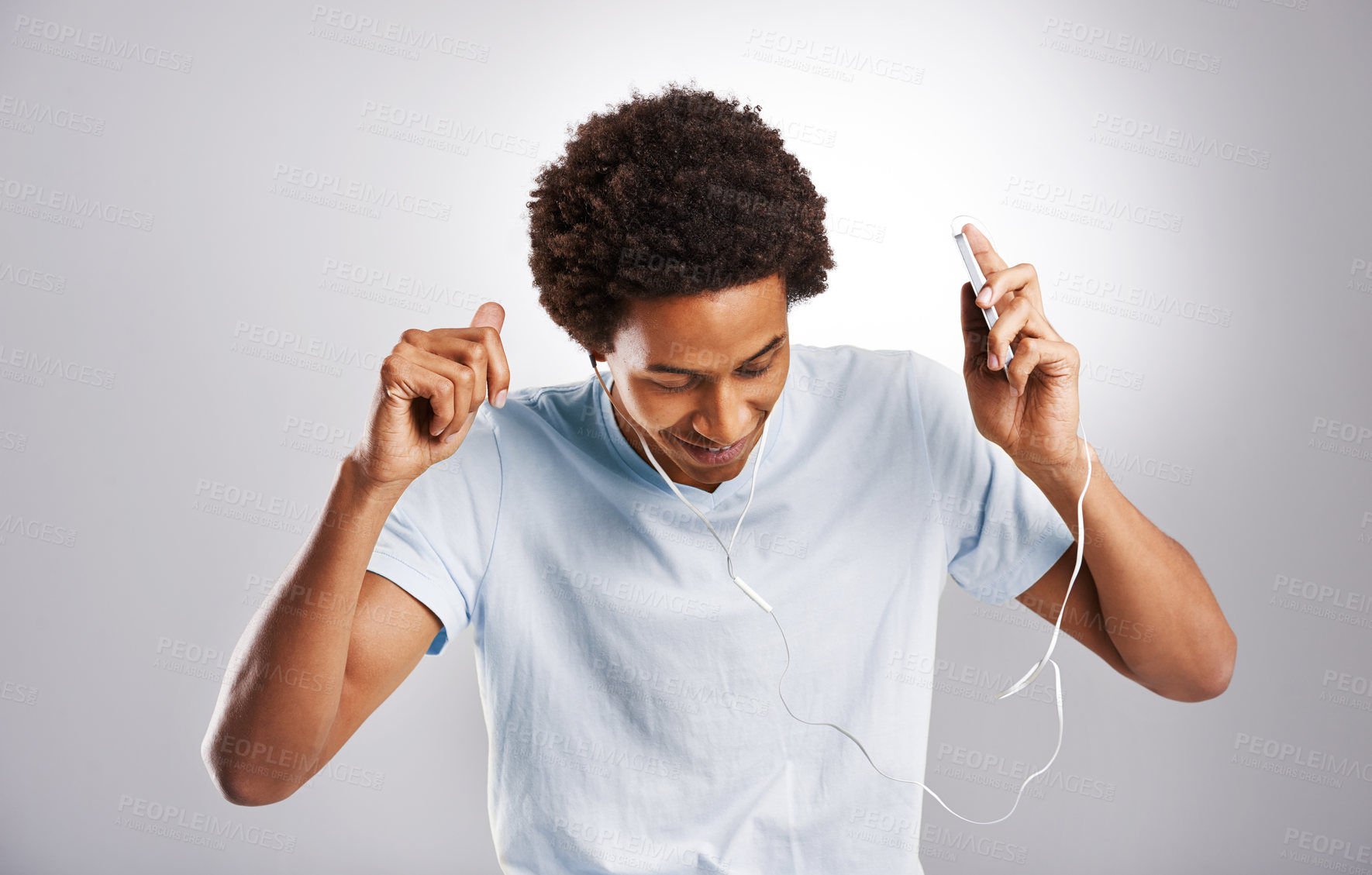 Buy stock photo Studio shot of a young man listening to music on his cellphone