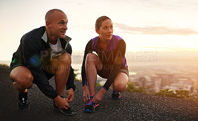 Buy stock photo Fitness, shoes and couple in a road for sunset running, training or morning cardio in nature together. Sneakers, shoelace and sports runner people outdoor for marathon, routine or performance workout