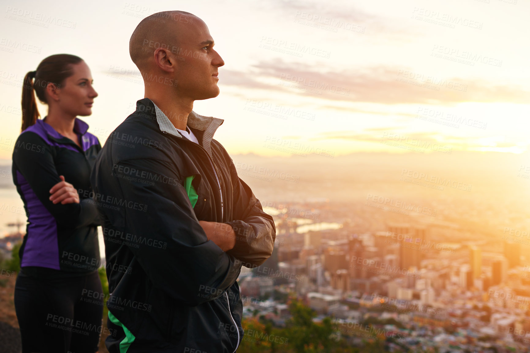 Buy stock photo Couple, sunset and fitness with vision on mountain for workout, exercise or outdoor training together. Man and woman thinking in confidence for ambition or health and wellness with view of the city