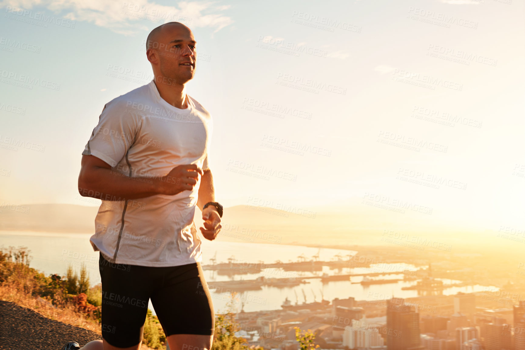 Buy stock photo Fitness, running and man on hill at sunset for health, wellness and strong body development. Workout, exercise and runner on path in nature for marathon training, performance and outdoor challenge.