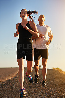 Buy stock photo Sunrise, marathon and friends running as workout or morning exercise for health and wellness together. Sport, man and woman runner run with athlete as training, sports or energy on a road