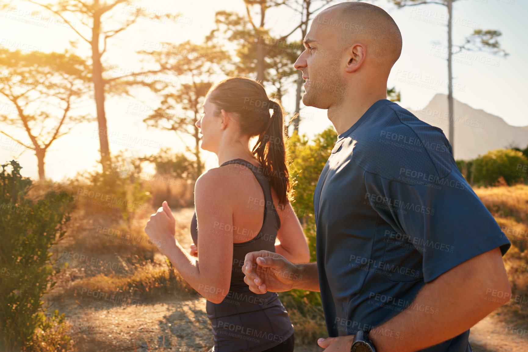Buy stock photo Sunrise, forest and friends running as exercise or morning workout for health and wellness together. Sport, man and woman runner on trail run with athlete as training in nature for sports or energy