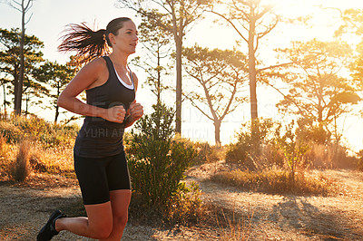 Buy stock photo Fitness, running and woman in nature at sunrise for health, wellness and strong body development. Workout, exercise and girl runner on path in woods for marathon training, performance and challenge.