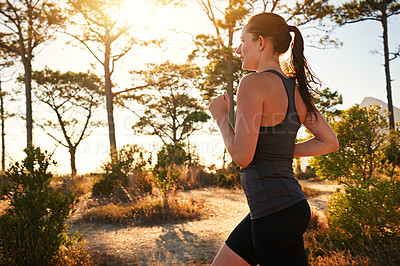 Buy stock photo Fitness, running and woman in forest for morning health, wellness and strong body development. Workout, exercise and girl runner on path in nature for marathon training, performance and challenge.