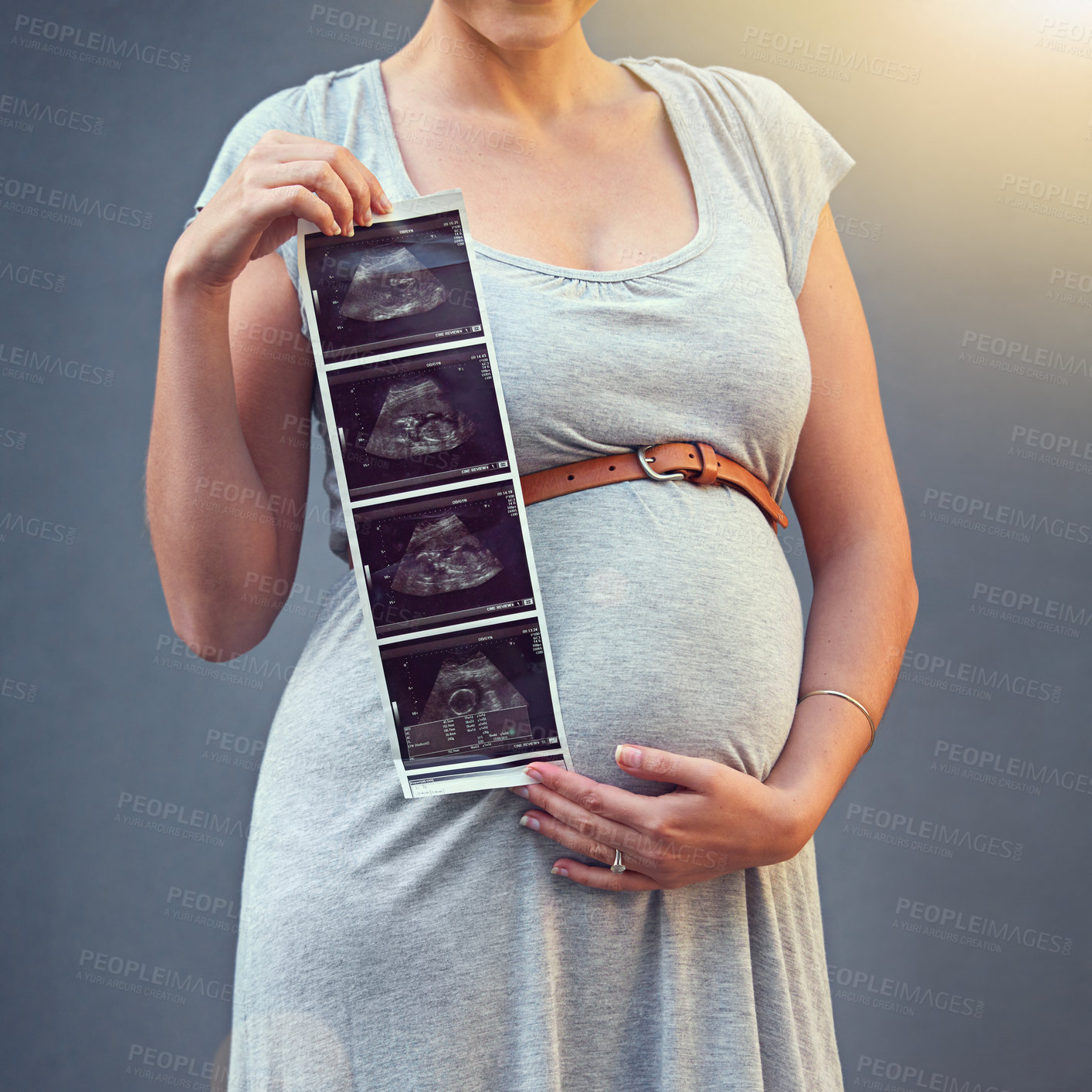 Buy stock photo Woman, pregnant and child ultrasound in studio for maternity shoot, album and baby shower. Mother, expecting and sonogram isolated on gray background for gender reveal, surrogacy and legal adoption