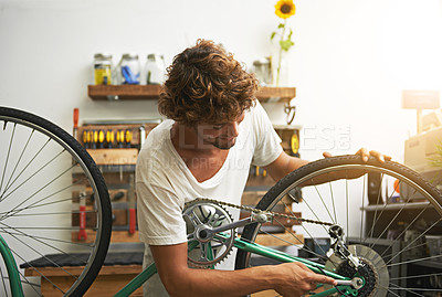 Buy stock photo Repair, bicycle and man in a workshop, happy and prepare for training, exercise and competition. Male biker, person and human fixing wheel, cycling and problem solving with maintenance and inspection