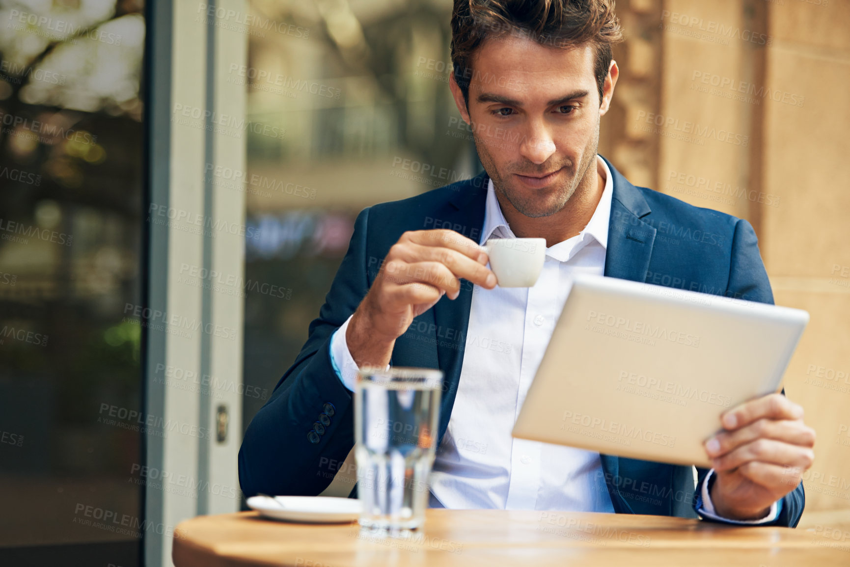 Buy stock photo Businessman, reading and outdoor at cafe with tablet for news, article or internet research in London. Online, communication and drink espresso with tech for social media and scroll blog on website