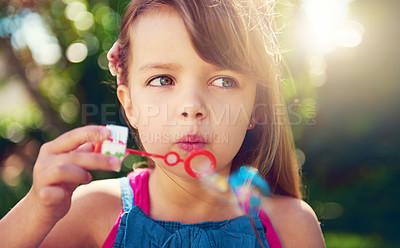 Buy stock photo Park, girl and child blowing bubbles in nature, relax and having fun outdoor. Toy, garden and face of kid with soap on summer vacation for recreation, leisure and playing game closeup for freedom