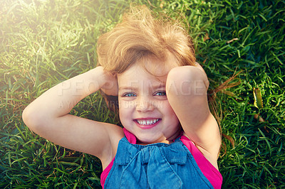 Buy stock photo Portrait, smile and top view of child on grass at park to relax, cute and lying outdoor to travel in nature. Face, above and happy girl on lawn in garden for holiday, summer and vacation in Australia