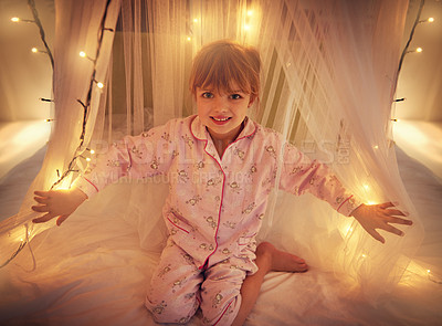 Buy stock photo Happy, lights and portrait of child in bedroom for resting, relaxing and dreaming in home. Night, smile and face of young girl with fairy light decoration on bed for fantasy, magic and childhood