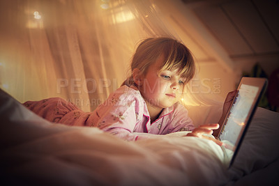 Buy stock photo Child, bedroom and tablet at night, browsing and watching with technology for screen and streaming. Little girl, tech and internet for online games or digital reading with touch and holding in bed