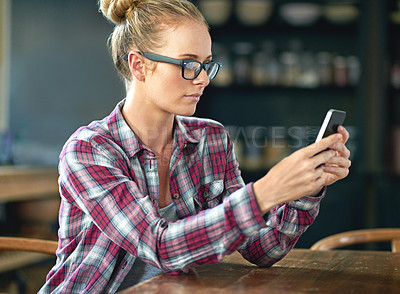 Buy stock photo Woman, reading and online with phone in cafe for communication, social media and mobile chat with glasses. Person, face and typing with smartphone for text message, internet scroll and email at table