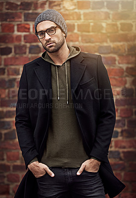 Buy stock photo Man, portrait and winter fashion by brick wall downtown for aesthetic, modern and expression for city culture. Male person, trendy urban outfit for streetwear style for creative career in retail
