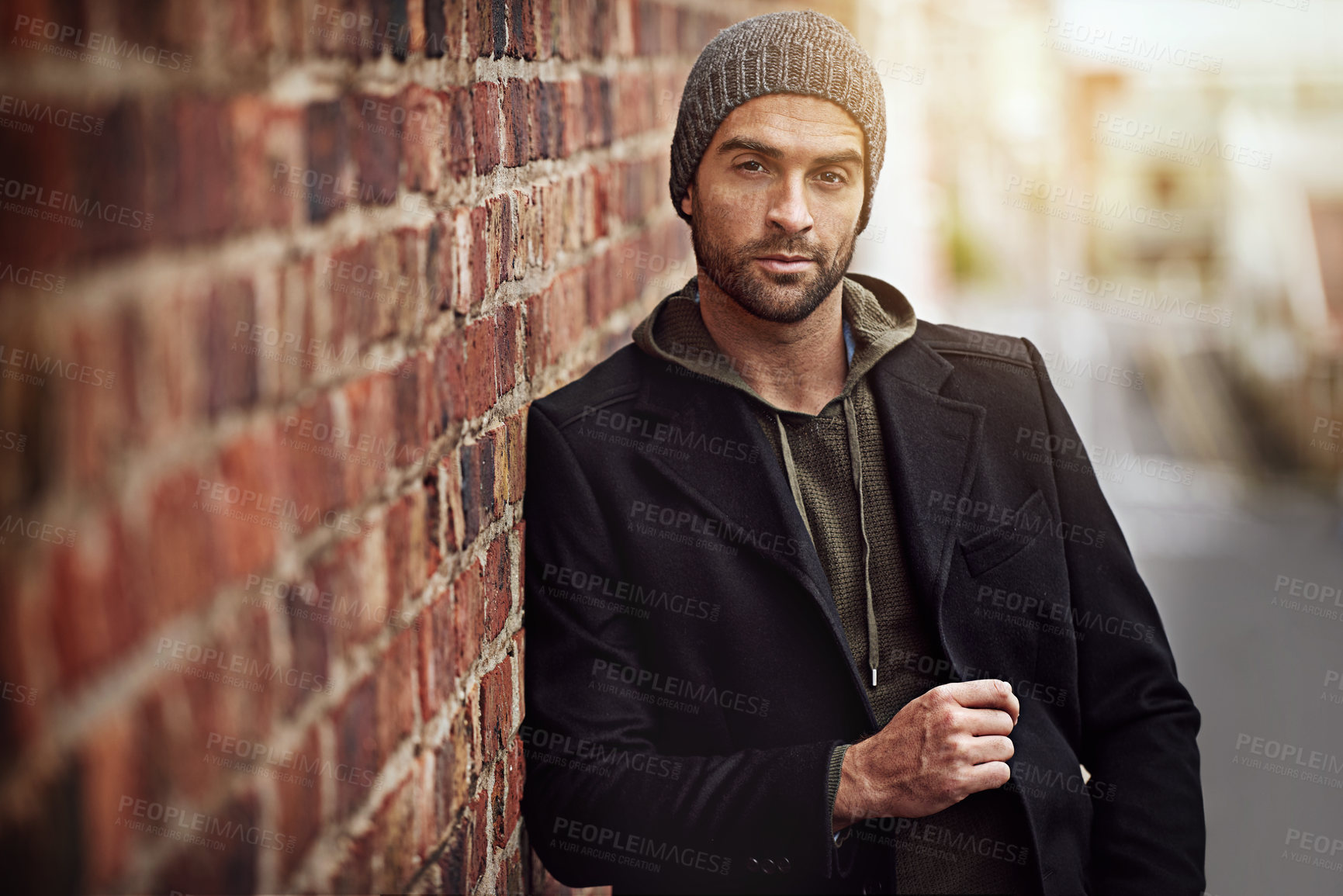 Buy stock photo Man, portrait and winter fashion by brick wall downtown for aesthetic, modern and vacation for city culture. Male person, trendy urban outfit for streetwear style for creative career in New York