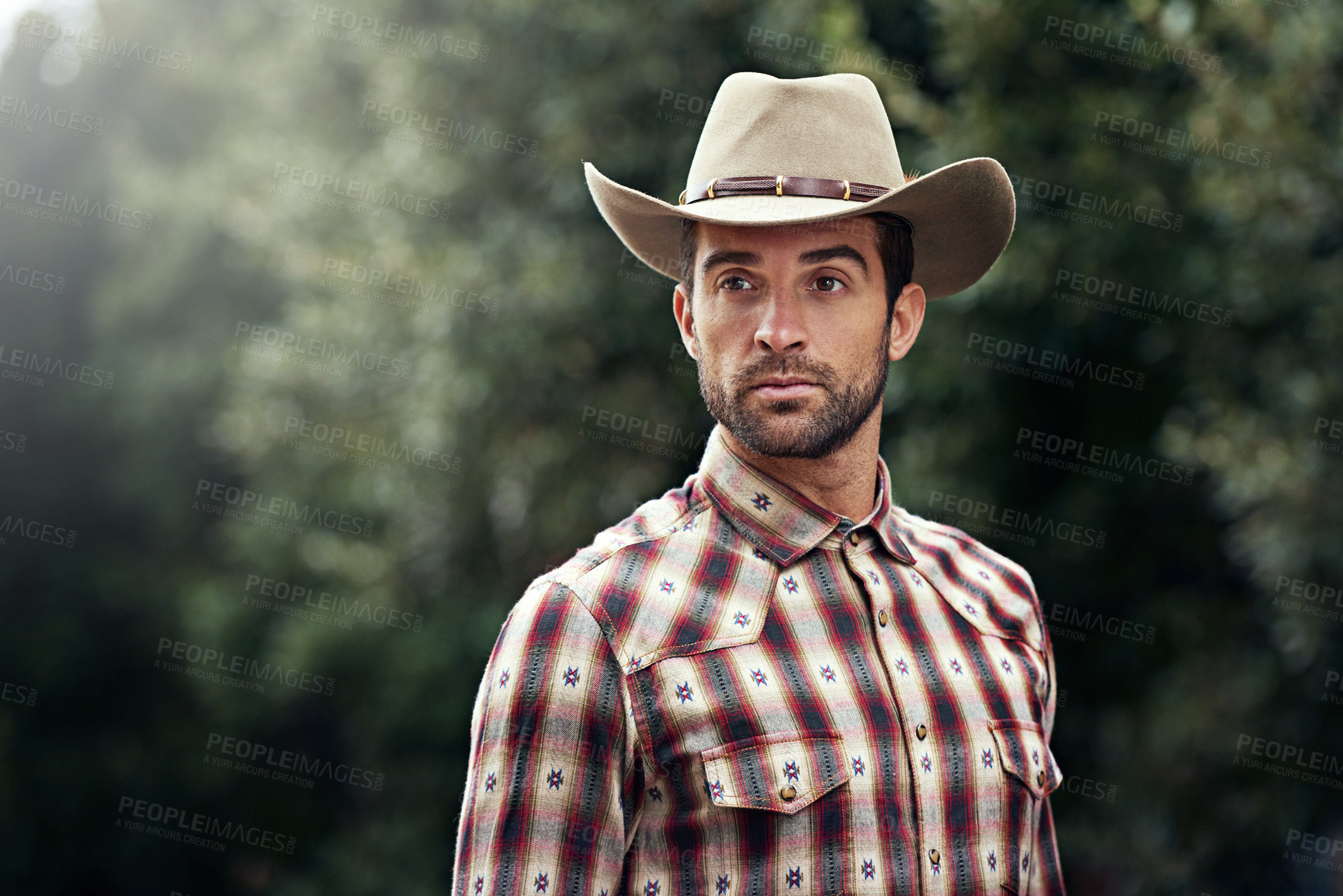 Buy stock photo Man, style and outdoor cowboy fashion, western culture and countryside ranch in Texas. Male person, hat and flannel clothes for farmer aesthetic, nature and plaid trend by trees or outside bush