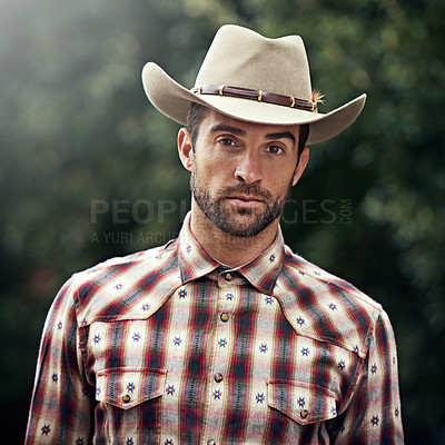 Buy stock photo Man, portrait and outdoor cowboy outfit, western culture and countryside ranch in Texas. Male person, hat and flannel trend for farmer aesthetic, nature and plaid style by trees or outside bush