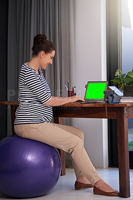 Buy stock photo Full length shot of a young pregnant woman working on a laptop on her office