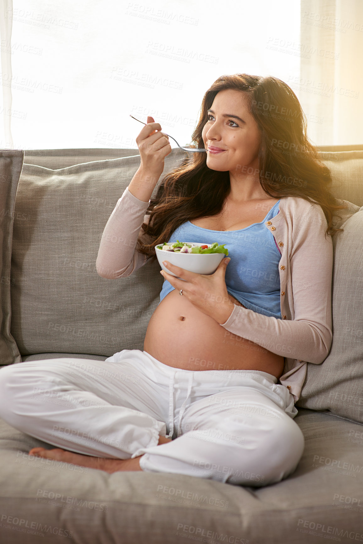 Buy stock photo Woman, sofa and pregnant with salad for eating with healthy diet in living room with smile for relax with maternity. Motherhood, child and parent on couch in home with prepare for baby with wellness