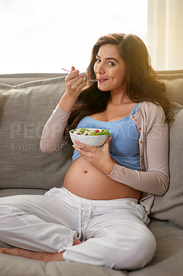 Buy stock photo Shot of a pregnant woman eating a healthy salad at home