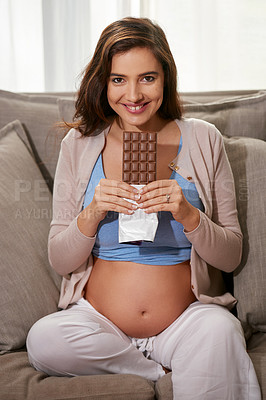 Buy stock photo Smile, chocolate and portrait of pregnant woman on sofa for relaxing with snack in living room at apartment. Happy, maternity and female person craving sweet dessert on couch in lounge of home.