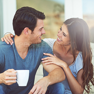 Buy stock photo Coffee, happy and couple on outdoor sofa for conversation, bonding or love on patio in morning. Smile, talking and young man and woman laughing and drinking cappuccino, latte or espresso at home.