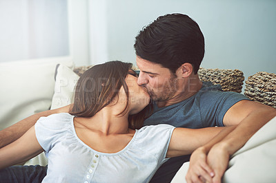 Buy stock photo Love, kissing and couple relaxing on sofa by patio cuddling and bonding for marriage at home. Happy, romance and young man and woman resting together on couch by outdoor porch of modern house.